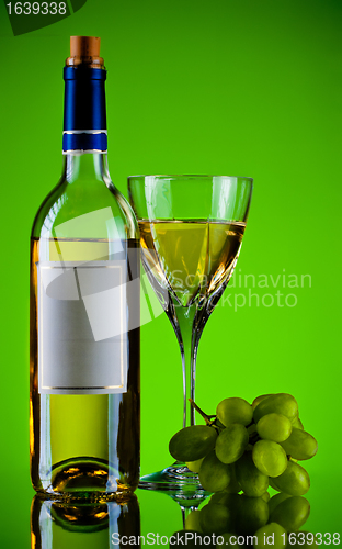 Image of bottle and glass of wine, grape bunch