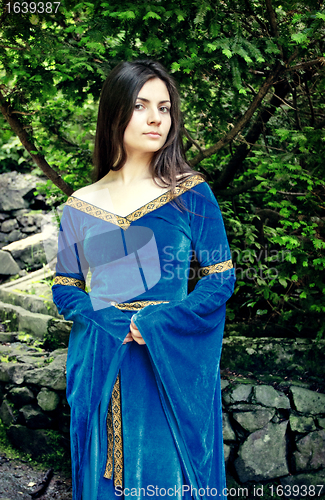 Image of beautiful princess standing near trees