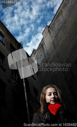 Image of sad girl with toy heart