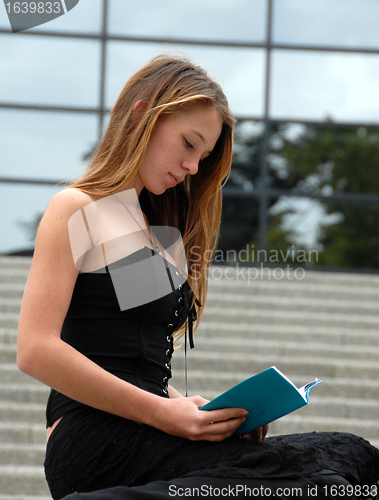 Image of sitting reading girl