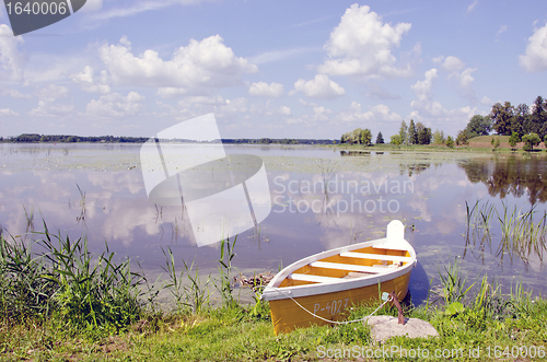 Image of Yellow boat moored shore. Amazing landscape 