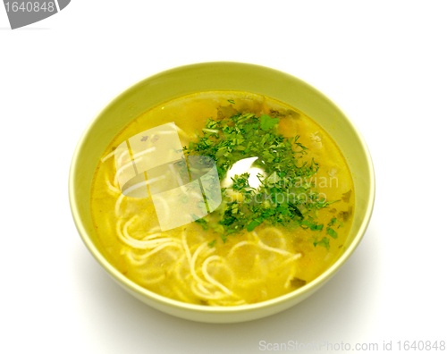 Image of Bowl homemade chicken noodle soup with greens and sour cream