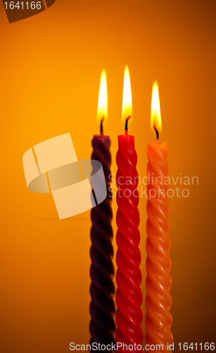 Image of Three Candles On Yellow