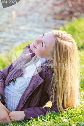 Image of Beautiful Woman Laying on River Bank