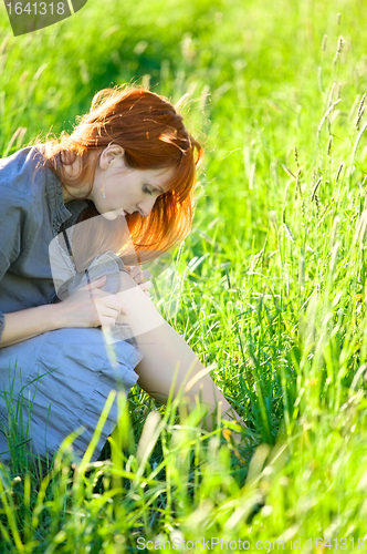 Image of redhead woman looking wound