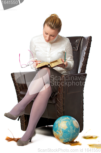 Image of serious teacher sitting in armchair