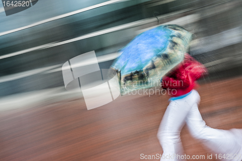 Image of Female running with umbrella