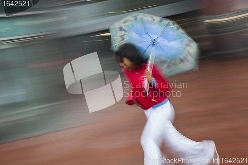 Image of Girl running with umbrella