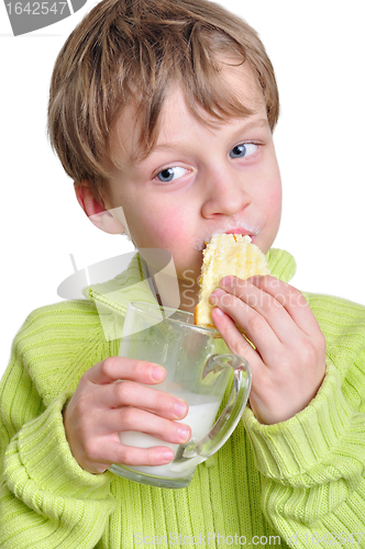 Image of child eating cake and dringking milk