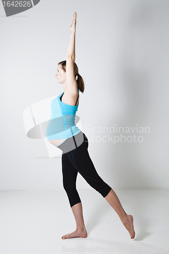 Image of Pregnant woman doing yoga exercise