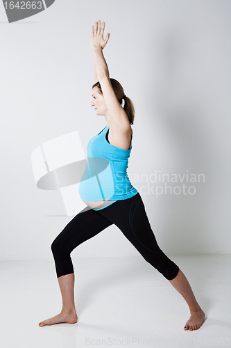 Image of Pregnant woman doing yoga exercise