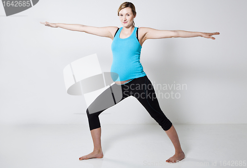 Image of Pregnant woman doing yoga exercise