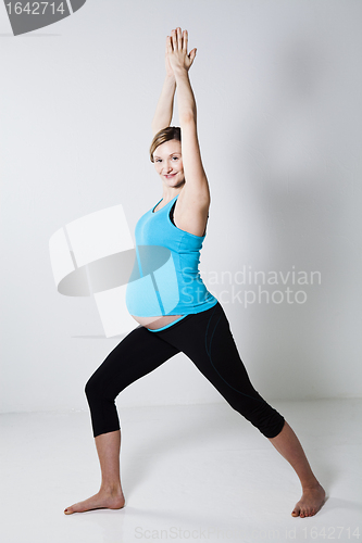 Image of Pregnant woman doing yoga exercise