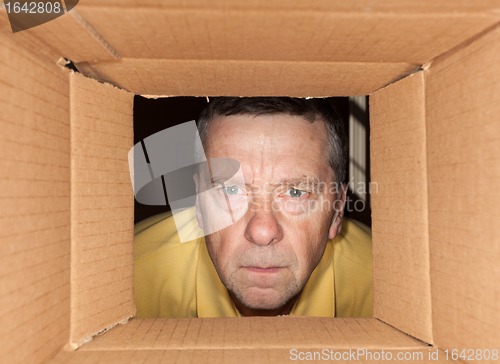 Image of Senior man staring into cardboard box