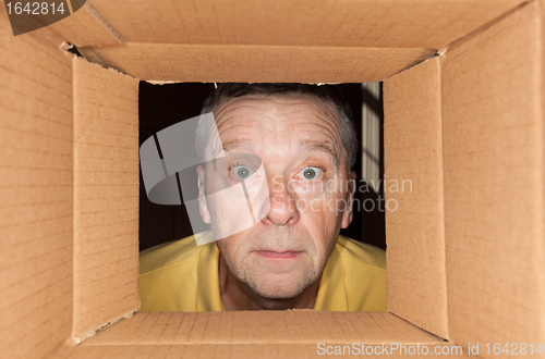 Image of Senior man staring into cardboard box