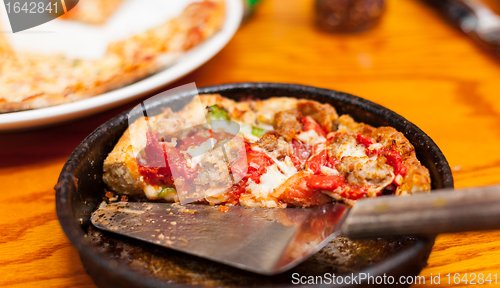 Image of Deep dish pizza in metal serving dish