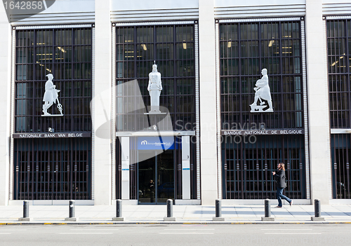 Image of Man walking past national Belgium bank