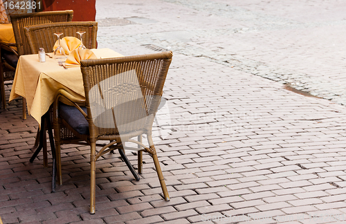 Image of Empty cafe tables in Brussels cobbled square