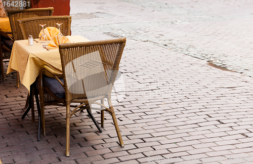 Image of Empty cafe tables in Brussels cobbled square