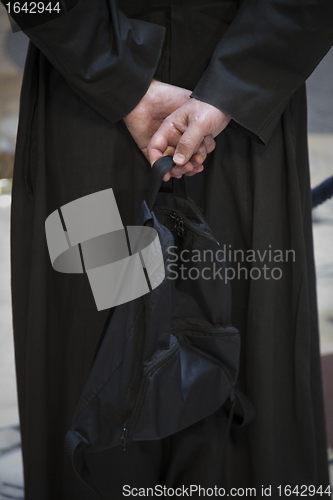 Image of Priest with rucksack