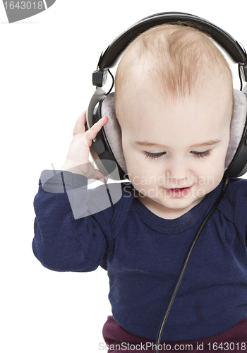 Image of young child with ear-phones listening to music