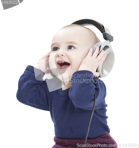 Image of young child with ear-phones listening to music