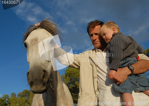 Image of father, son and horse