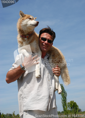 Image of man and siberian husky