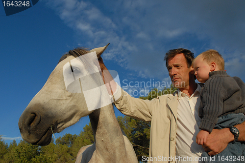 Image of father, son and horse