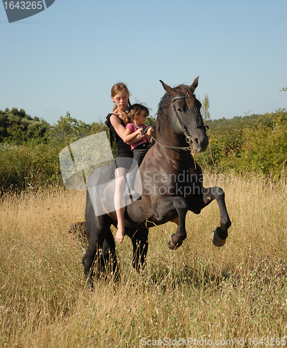 Image of rearing stallion, teen and child