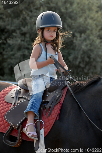 Image of baby riding girl