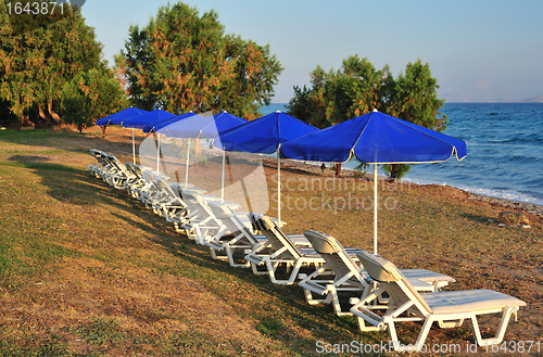 Image of Beach with blue parasols 