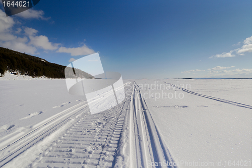 Image of Snowmobile trail stretching into the distance