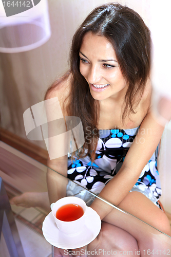 Image of girl with white cup of tea