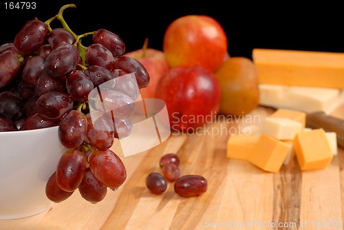 Image of Wide view of fruit and cheese on cutting board