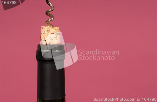 Image of Cork being pulled out of wine bottle with a corkscrew