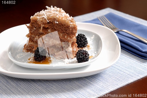 Image of A slice of German Chocolate cake with blackberries