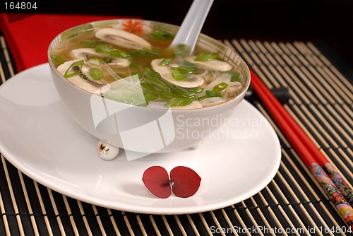 Image of Asian chicken, glass noodle and rice soup with mushrooms and sca