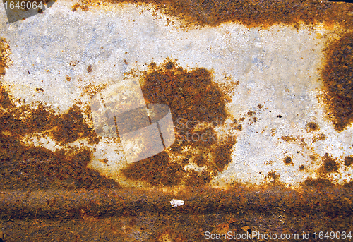 Image of Background of ancient cracked rusty tin wall. 