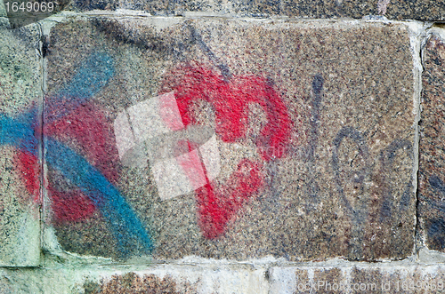 Image of heart painted ancient stone block wall background 