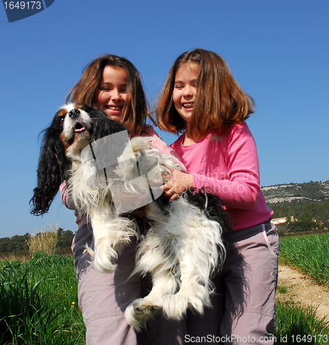 Image of twins and dog