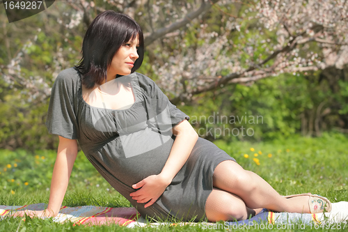 Image of beautiful pregnant woman in garden