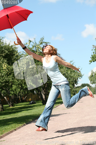 Image of smiling girl jumping with red umbrella