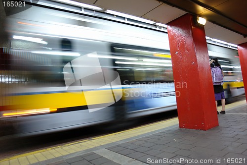 Image of Bus leaving depot female waiting