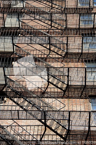 Image of zig zagging fire escape on back of old apartment building