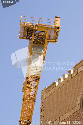 Image of Construction Crane next to a Building