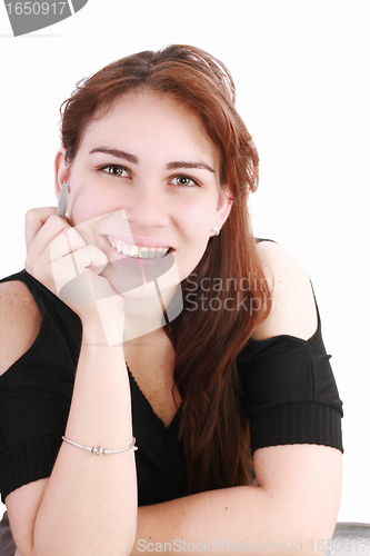 Image of Portrait of a pretty young businesswoman at the office desk hold