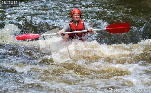 Image of teenager white water kayaking