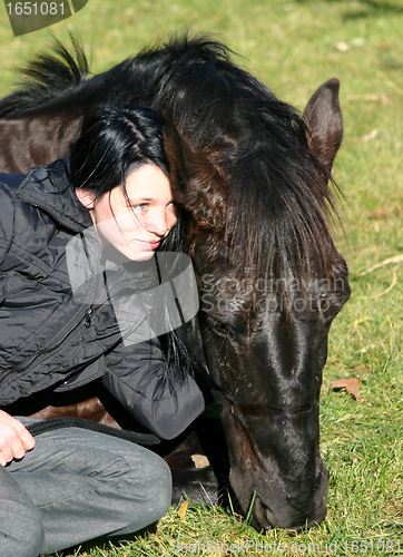 Image of horse laid down and riding girl