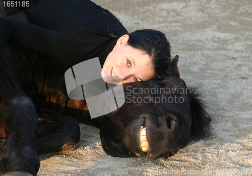 Image of horse laid down and teen